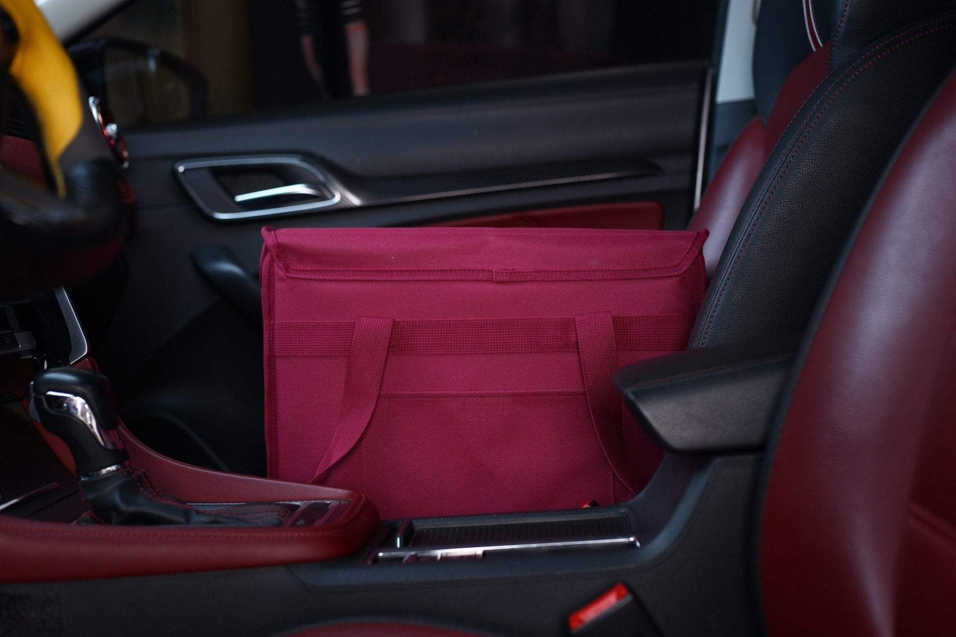 back view of upright insulated pizza bag in a car's storage compartment